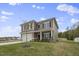 Two-story house with gray siding, white garage door, and landscaped lawn at 148 Cumberland Dr, Sanford, NC 27332