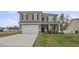 Two-story house with gray siding, white garage door, and landscaped lawn at 148 Cumberland Dr, Sanford, NC 27332