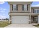 White double-car garage with stone accents at 148 Cumberland Dr, Sanford, NC 27332