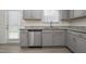 Gray cabinets, granite countertops, and stainless steel dishwasher at 148 Cumberland Dr, Sanford, NC 27332