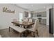 Kitchen with gray cabinets, wooden dining table, and stainless steel appliances at 148 Cumberland Dr, Sanford, NC 27332