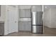 Kitchen features stainless steel refrigerator and gray cabinets at 148 Cumberland Dr, Sanford, NC 27332