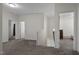 Upstairs hallway with gray carpet and access to bedrooms at 148 Cumberland Dr, Sanford, NC 27332