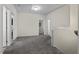 Upstairs hallway with carpet and doors to bedrooms at 148 Cumberland Dr, Sanford, NC 27332