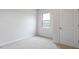 Bedroom featuring natural light from a window, adjacent to a door for easy access at 155 Scenic Rock Dr, Youngsville, NC 27596