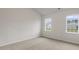 Spacious bedroom with neutral carpeting and two large windows at 155 Scenic Rock Dr, Youngsville, NC 27596