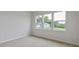 This is a light-filled bedroom with three large windows offering outdoor views at 155 Scenic Rock Dr, Youngsville, NC 27596