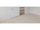 Simple bedroom with neutral carpeting and door to hallway at 155 Scenic Rock Dr, Youngsville, NC 27596