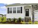 Charming home entrance featuring stone accents, black shutters, and well-maintained landscaping at 155 Scenic Rock Dr, Youngsville, NC 27596