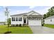 Charming single-Gathering home with stone accents, black shutters, a two-car garage, and manicured lawn at 155 Scenic Rock Dr, Youngsville, NC 27596