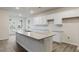 Modern kitchen with white cabinets, granite countertops, and island at 155 Scenic Rock Dr, Youngsville, NC 27596
