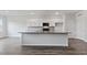 Modern kitchen features an island, stainless steel appliances, and white cabinets at 155 Scenic Rock Dr, Youngsville, NC 27596