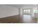 Open-concept living area with hardwood floors, bright windows, and open space at 155 Scenic Rock Dr, Youngsville, NC 27596