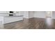 Open-concept living area with hardwood floors, flowing into a modern kitchen with a center island at 155 Scenic Rock Dr, Youngsville, NC 27596
