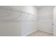 Empty walk-in closet features wire shelving and neutral carpet at 155 Scenic Rock Dr, Youngsville, NC 27596