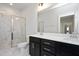 Modern bathroom with double vanity, frameless shower, and dark cabinetry at 1549 Piney Fls Dr, Wendell, NC 27591