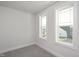 Bright bedroom with neutral walls and carpet, featuring two large windows at 1549 Piney Fls Dr, Wendell, NC 27591