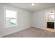 Well-lit bedroom with carpet floors and a window overlooking the neighborhood at 1549 Piney Fls Dr, Wendell, NC 27591