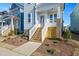 Front entrance with wooden stairs and brick base at 1549 Piney Fls Dr, Wendell, NC 27591