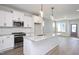 Kitchen with white cabinets, granite countertops and island at 1549 Piney Fls Dr, Wendell, NC 27591