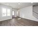 Living room with hardwood floors and stairs to the second floor at 1549 Piney Fls Dr, Wendell, NC 27591