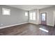 Living room with gray walls, hardwood floors, and a purple door at 1549 Piney Fls Dr, Wendell, NC 27591