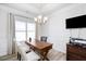 Bright dining room with wood table, chandelier, and hardwood floors at 168 Northwood Dr, Fuquay Varina, NC 27526