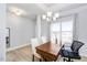 Dining room features hardwood floors, chandelier, and large window at 168 Northwood Dr, Fuquay Varina, NC 27526