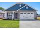 Newly constructed home with gray and blue siding, two car garage, and landscaped lawn at 168 Northwood Dr, Fuquay Varina, NC 27526