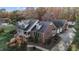 Aerial view of two-story brick home, landscaping, and shed at 1991 Webster Grove Dr, Mebane, NC 27302