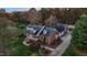 Aerial view of brick home with a landscaped yard, and a large driveway in a wooded area at 1991 Webster Grove Dr, Mebane, NC 27302