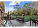Spacious deck overlooks fenced backyard with mature trees and shed at 1991 Webster Grove Dr, Mebane, NC 27302