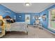 Blue bedroom with rocking chair and ample natural light at 1991 Webster Grove Dr, Mebane, NC 27302