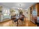Bright dining room with hardwood floors, large windows, and built in hutch at 1991 Webster Grove Dr, Mebane, NC 27302