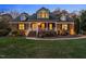 Brick home with landscaped yard, charming porch, and updated lighting at 1991 Webster Grove Dr, Mebane, NC 27302