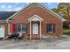 Brick ranch home with a small patio and landscaping at 1991 Webster Grove Dr, Mebane, NC 27302