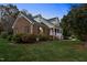 Brick home with side entry and landscaped yard at 1991 Webster Grove Dr, Mebane, NC 27302