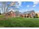Brick house exterior with landscaped yard and shed at 1991 Webster Grove Dr, Mebane, NC 27302