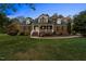 Two-story brick home with front porch and landscaping at 1991 Webster Grove Dr, Mebane, NC 27302