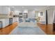 Modern kitchen with white cabinets, stainless steel appliances, and hardwood floors at 1991 Webster Grove Dr, Mebane, NC 27302