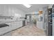 Bright kitchen with white cabinets, granite counters, and tile flooring at 1991 Webster Grove Dr, Mebane, NC 27302