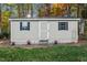 Tan storage shed with double doors and two windows at 1991 Webster Grove Dr, Mebane, NC 27302