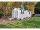 Tan storage shed with ramp and side door at 1991 Webster Grove Dr, Mebane, NC 27302