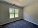 A cozy bedroom features a large window offering natural light and exterior views at 286 Longbow Dr, Middlesex, NC 27557