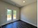 Bedroom featuring stylish flooring and glass patio doors that bring in natural light and lead to a private deck at 286 Longbow Dr, Middlesex, NC 27557