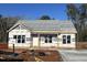 New construction home with vinyl siding and a covered porch at 286 Longbow Dr, Middlesex, NC 27557