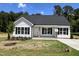 Charming single-story home with white siding, black shutters, and a well-manicured lawn at 286 Longbow Dr, Middlesex, NC 27557