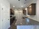 Modern kitchen with dark cabinets, granite countertops, stainless steel appliances and decorative pendant lighting at 286 Longbow Dr, Middlesex, NC 27557