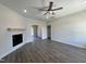Bright living room boasts wood floors, fireplace, ceiling fan, and recessed lighting, ready for your personal touch at 286 Longbow Dr, Middlesex, NC 27557