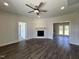Spacious living room featuring wood floors, a ceiling fan, and a fireplace with a wooden mantle at 286 Longbow Dr, Middlesex, NC 27557